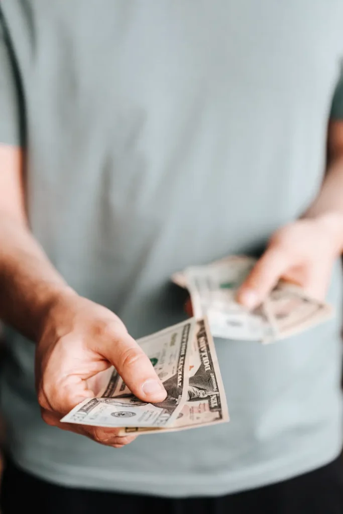 Free man paying with American dollars Stock Photo