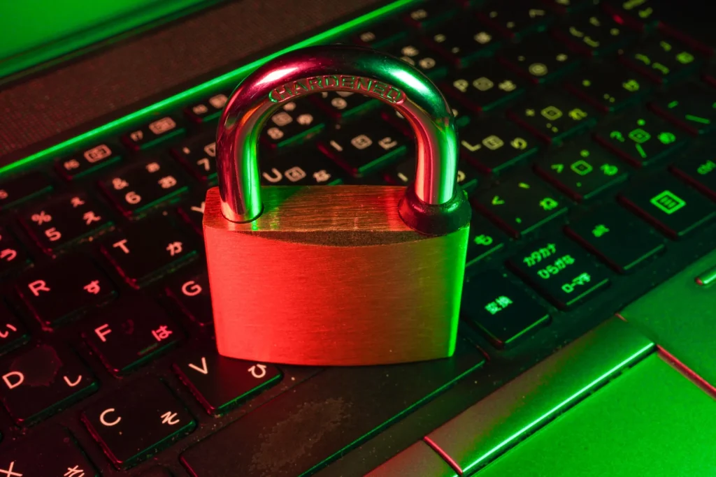 red cybersecurity padlock on black computer keyboard